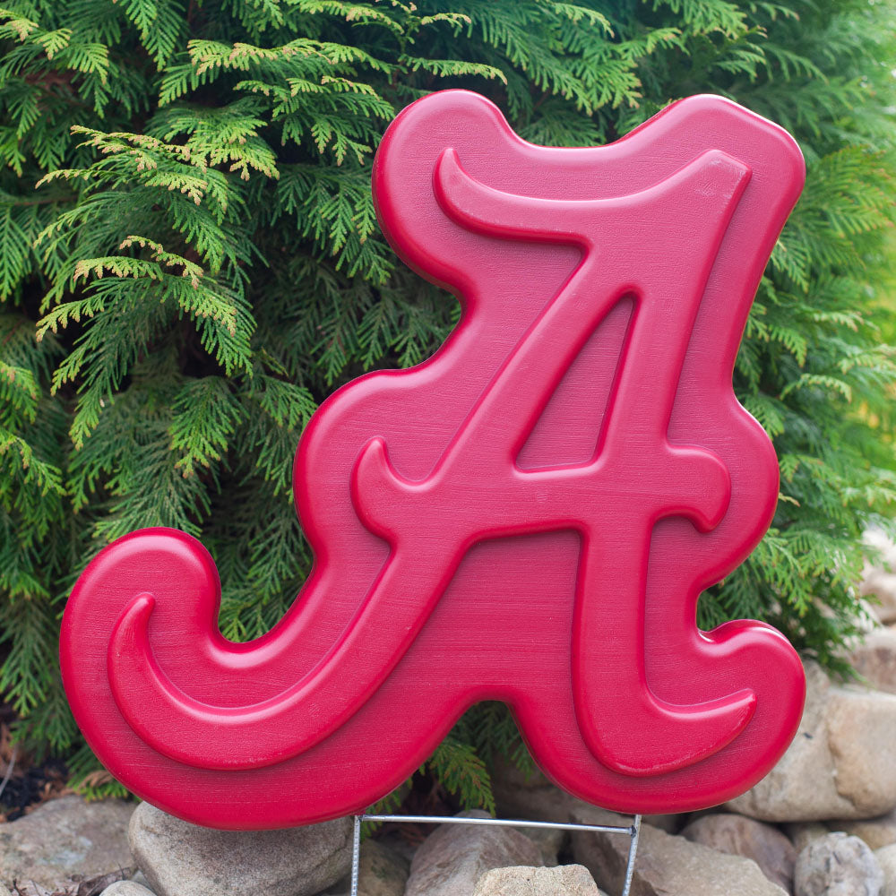 Alabama Crimson Tide Lawn Ornament - in garden with rocks